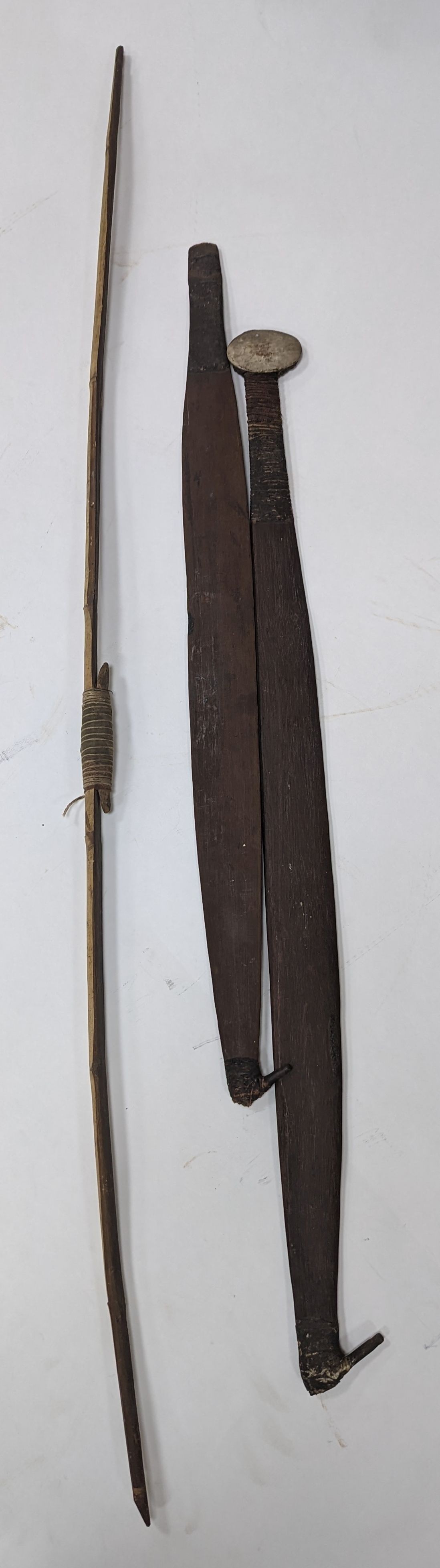 Two chip-carved paddle blades and bow, possibly Fijian.